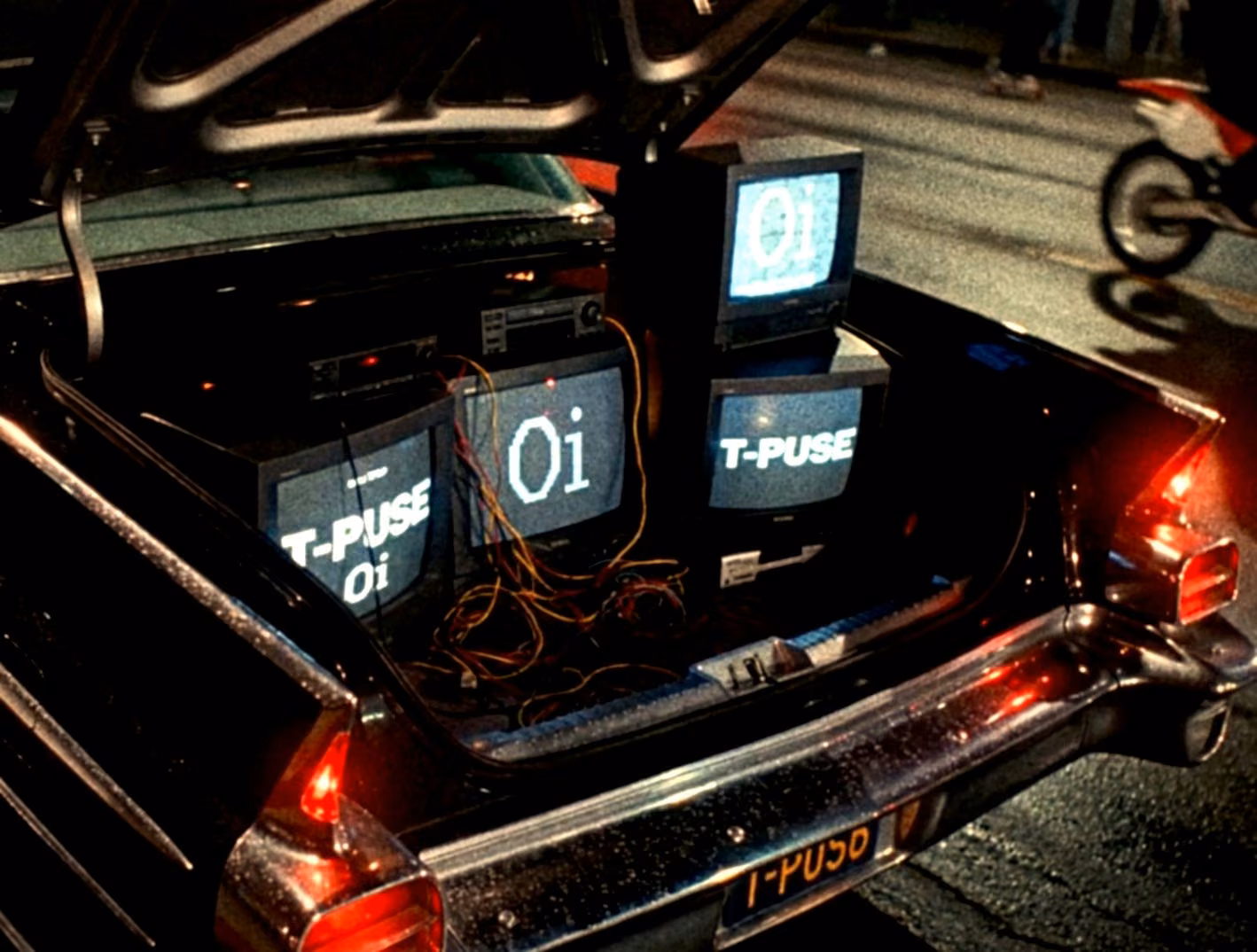 CRT monitors and cables installed in the trunk of a lowrider