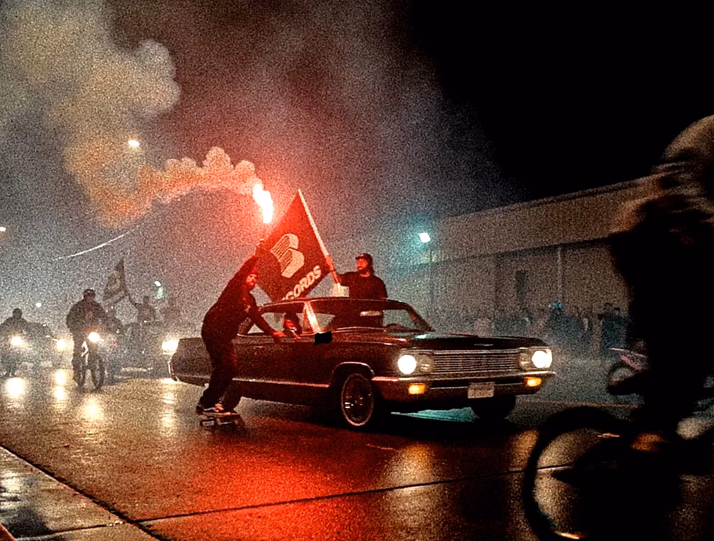 Lowrider, flags and flares on a rain-soaked Clüb De Combat set