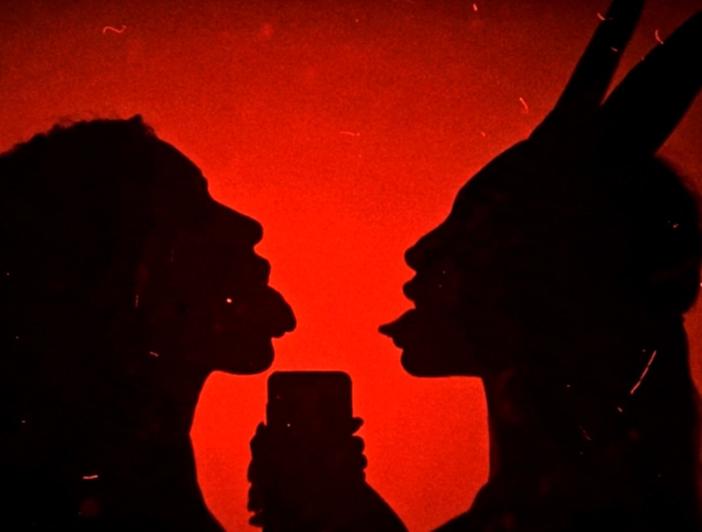 DvirNuns and Dox facing each other inside a saturated red visual world