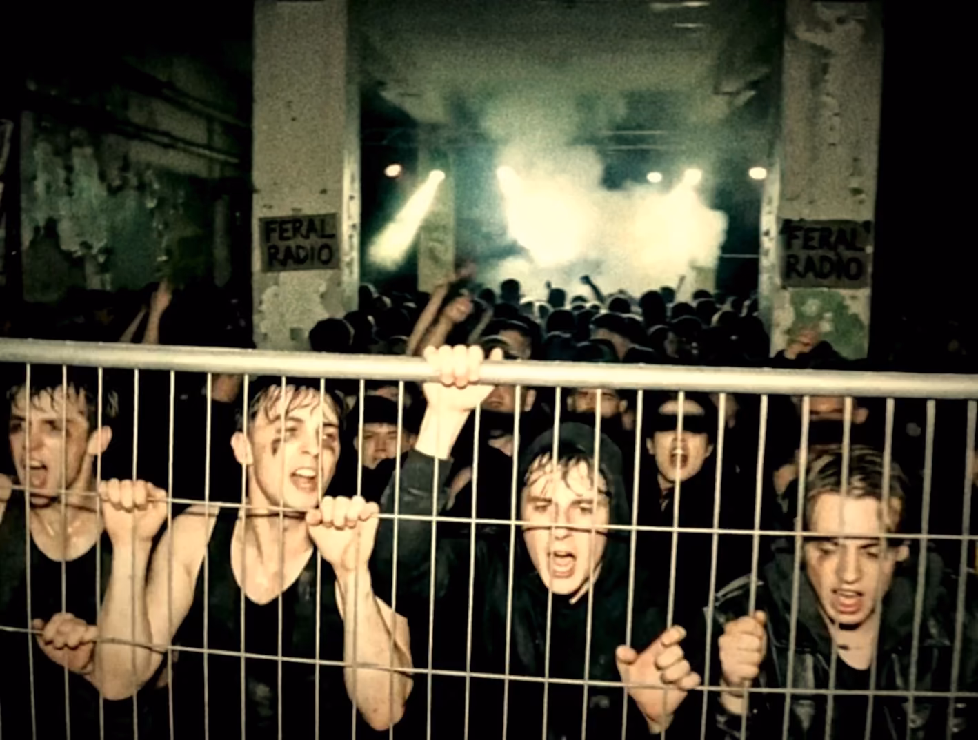 Crowd pressed against a barrier at an underground show